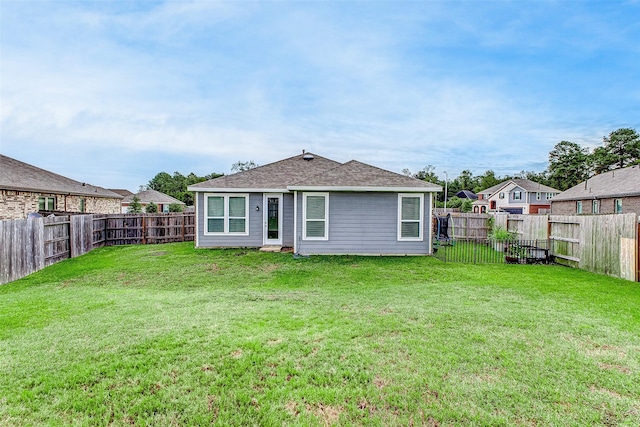 rear view of property with a lawn