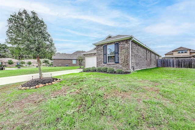 view of side of property featuring a lawn and a garage