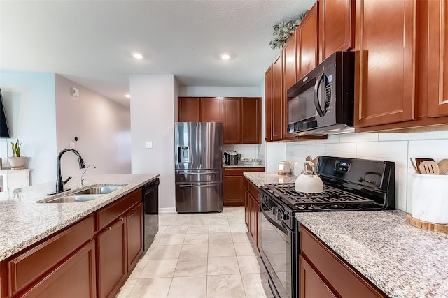 kitchen featuring sink, light stone counters, decorative backsplash, light tile patterned floors, and black appliances