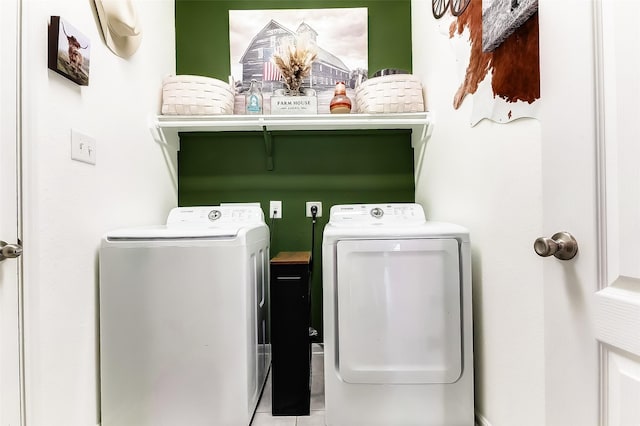 laundry room featuring separate washer and dryer and light tile patterned floors