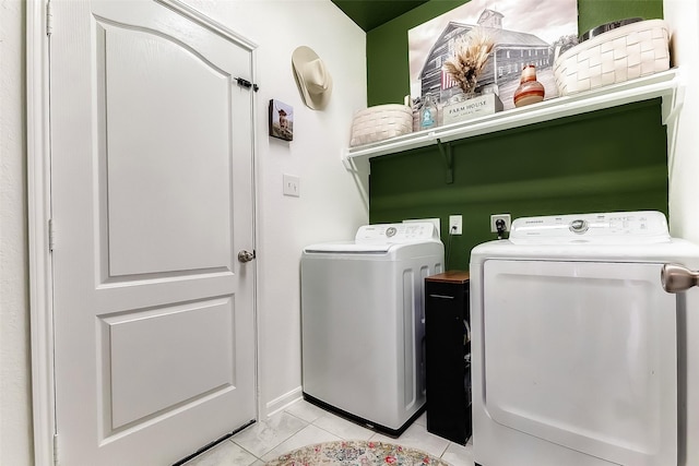 washroom with independent washer and dryer and light tile patterned floors