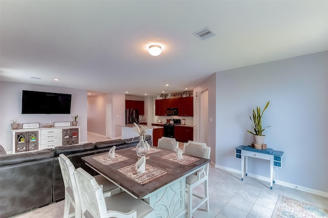 dining space featuring light tile patterned floors