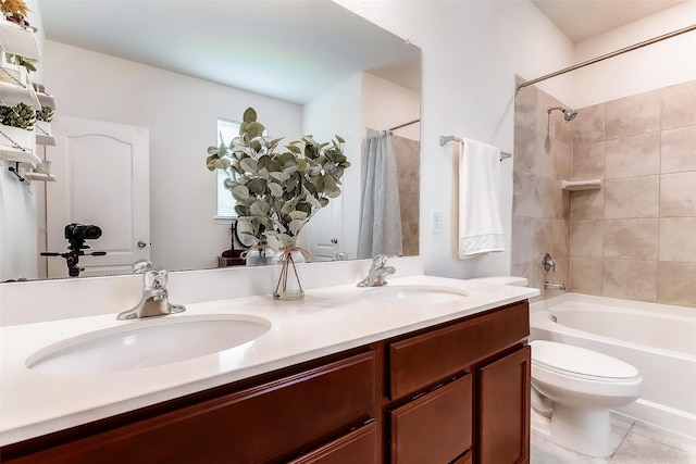 full bathroom with tile patterned floors, shower / bathtub combination with curtain, vanity, and toilet