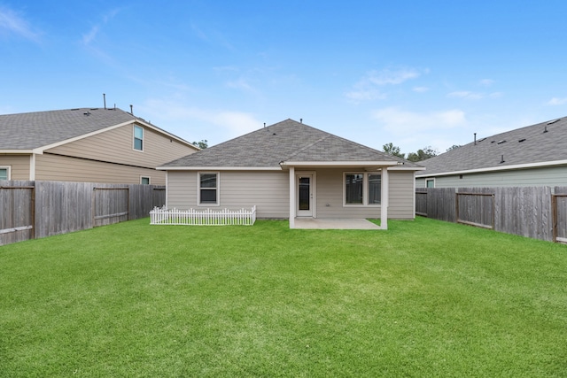 back of property with a patio and a yard