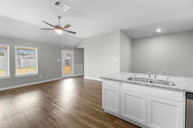 kitchen featuring dark wood-type flooring, white cabinetry, sink, and vaulted ceiling