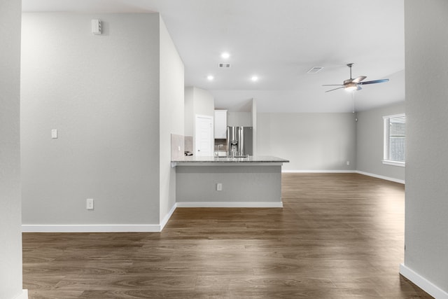 unfurnished living room featuring dark hardwood / wood-style floors and ceiling fan