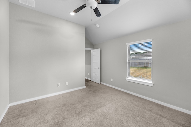 carpeted empty room featuring lofted ceiling and ceiling fan