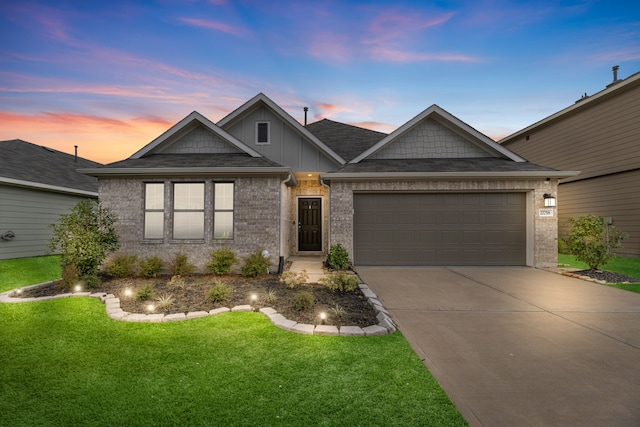 view of front facade with a garage and a yard