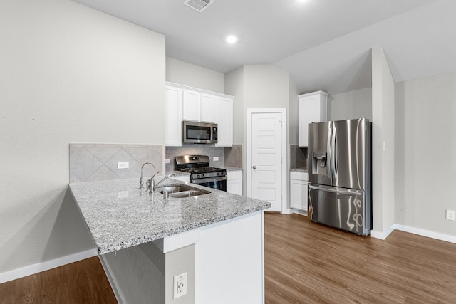 kitchen featuring sink, appliances with stainless steel finishes, backsplash, white cabinets, and dark hardwood / wood-style flooring