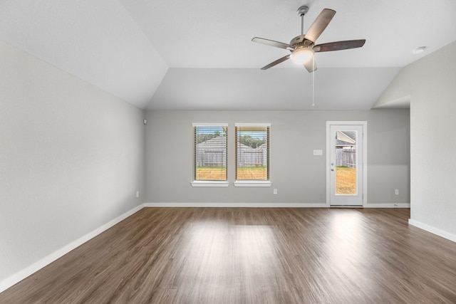 unfurnished living room featuring dark wood-type flooring, ceiling fan, and vaulted ceiling