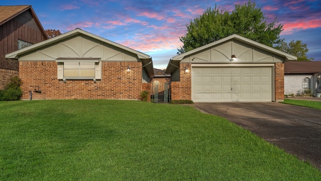 view of front of house with a garage and a yard