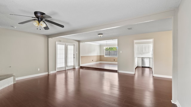 unfurnished room with a textured ceiling, dark hardwood / wood-style floors, and ceiling fan