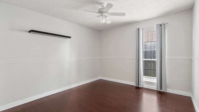 empty room with ceiling fan, a textured ceiling, and dark hardwood / wood-style floors