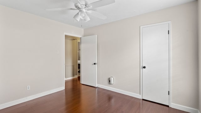 unfurnished bedroom featuring dark hardwood / wood-style flooring and ceiling fan