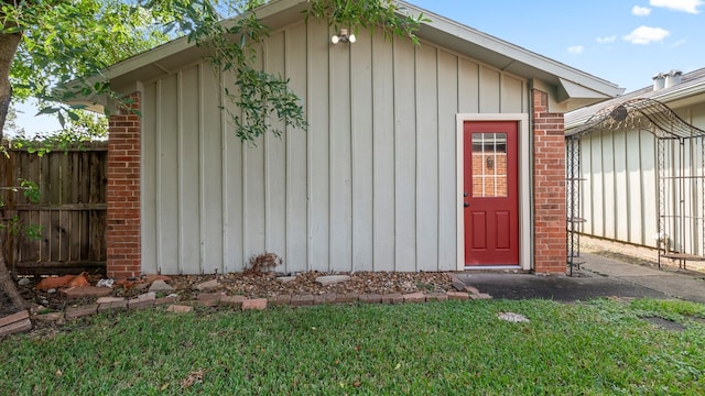 view of outbuilding featuring a lawn