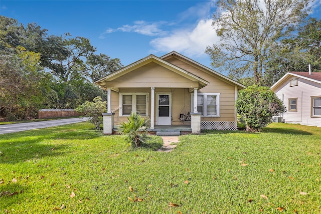 bungalow-style house featuring a front lawn and covered porch