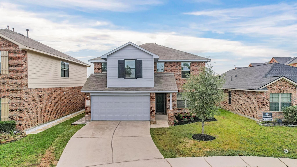 view of front facade featuring a front yard and a garage