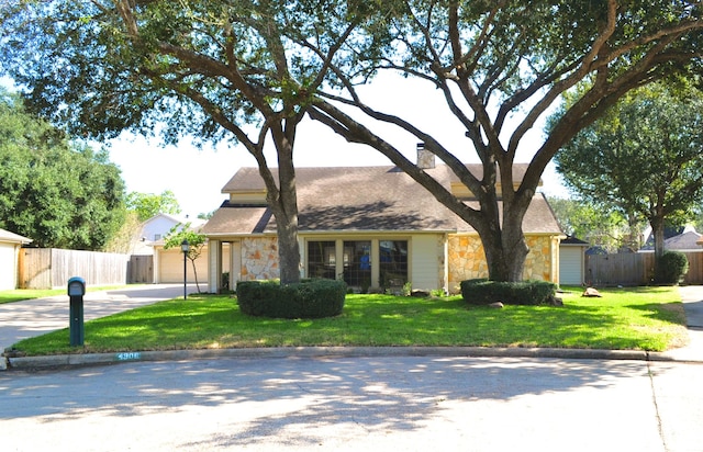 single story home with a garage and a front lawn