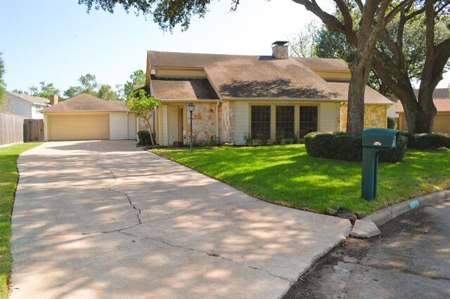 view of front of house with a garage and a front lawn