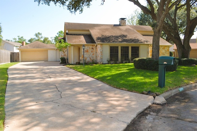 view of front of home with a garage and a front yard