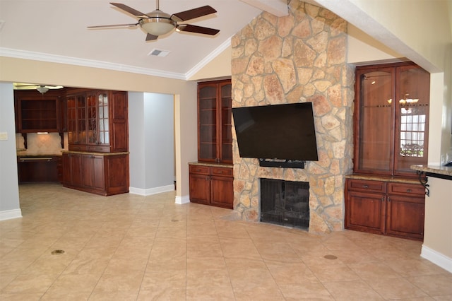 unfurnished living room with lofted ceiling with beams, a fireplace, ceiling fan, and crown molding