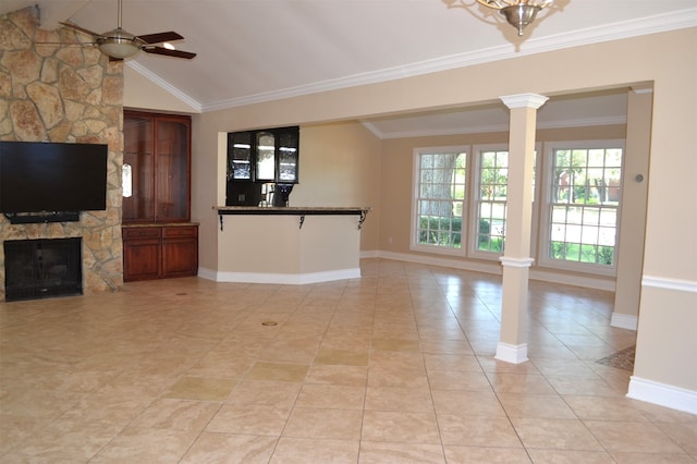 unfurnished living room with ornate columns, ornamental molding, lofted ceiling, and ceiling fan