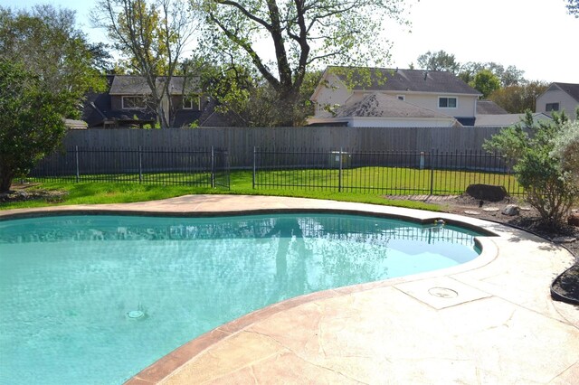 view of pool with a yard