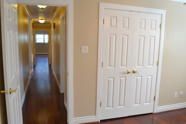 hallway with dark wood-type flooring and crown molding