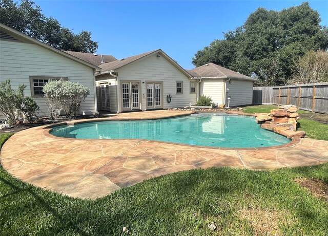 view of swimming pool featuring a patio and french doors