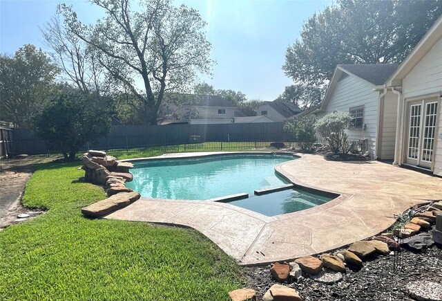 view of pool with a lawn and a patio