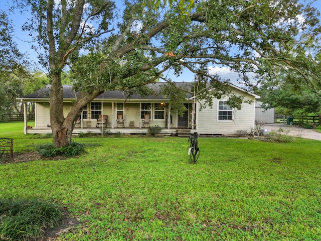 view of front of home with a porch and a front yard