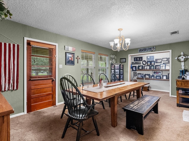 dining area featuring carpet flooring, a textured ceiling, and a notable chandelier