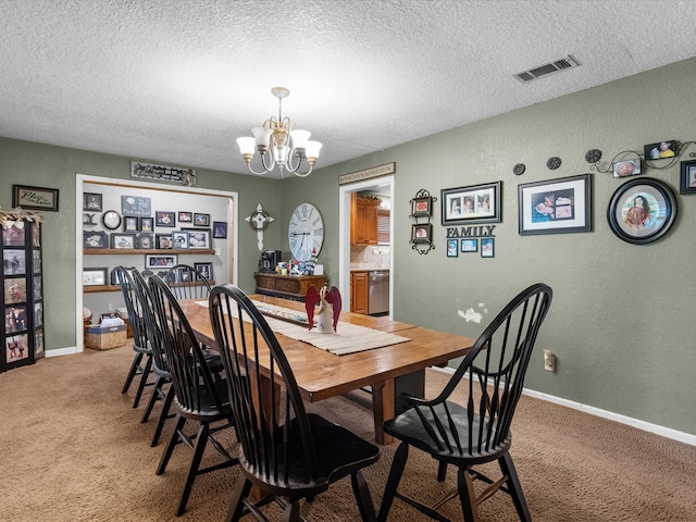 carpeted dining room with a textured ceiling and a notable chandelier