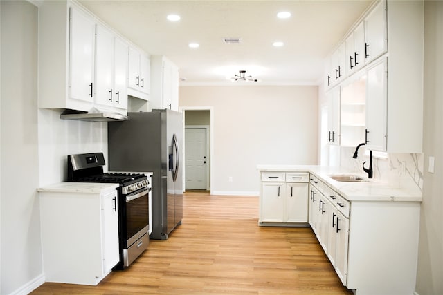 kitchen featuring stainless steel appliances, light hardwood / wood-style floors, white cabinetry, sink, and ornamental molding