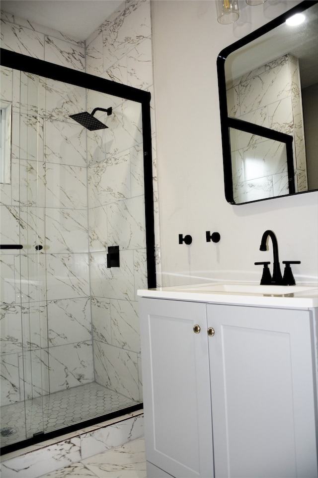 bathroom with vanity and a shower with shower door