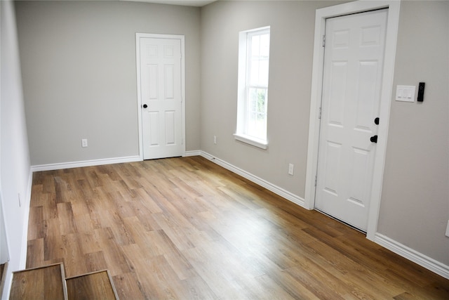 empty room with light hardwood / wood-style floors