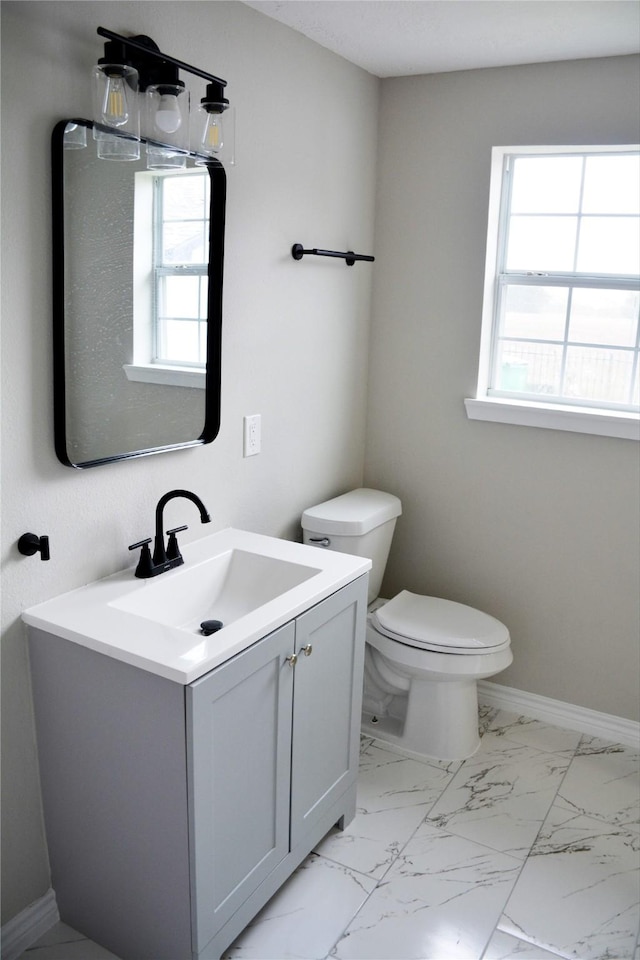 3321 Michigan St, Baytown, TX 77520 - bathroom featuring toilet, vanity, healthy amount of natural light, and baseboards