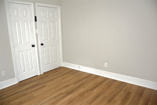 unfurnished bedroom featuring hardwood / wood-style flooring