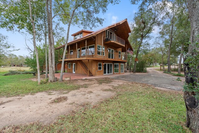 back of property with stairs and a deck