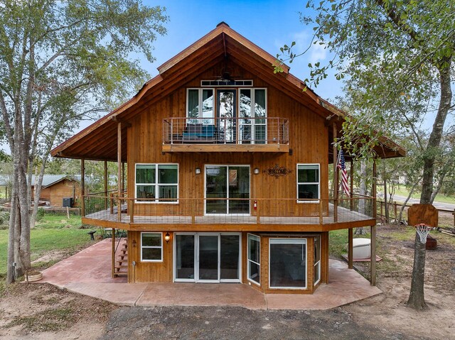 back of property with a patio area and a balcony