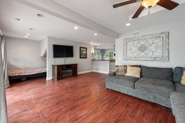 living area with baseboards, visible vents, wood finished floors, a fireplace, and recessed lighting