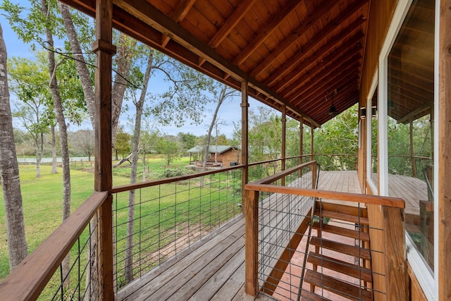 wooden deck featuring a lawn