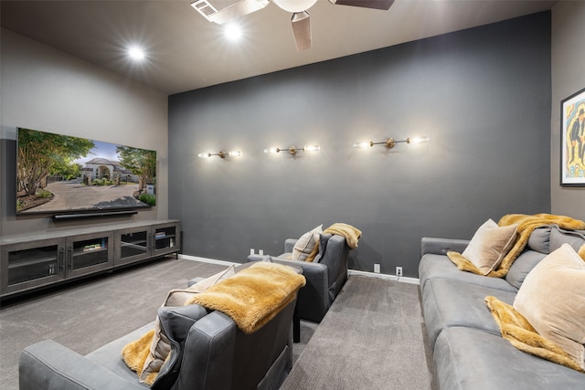 cinema room with ceiling fan and carpet