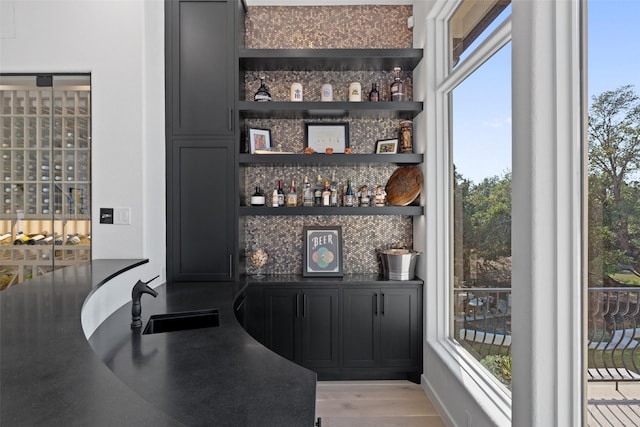 bar featuring sink and light wood-type flooring