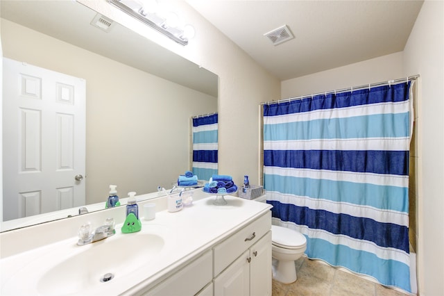 bathroom with toilet, vanity, tile patterned floors, and curtained shower