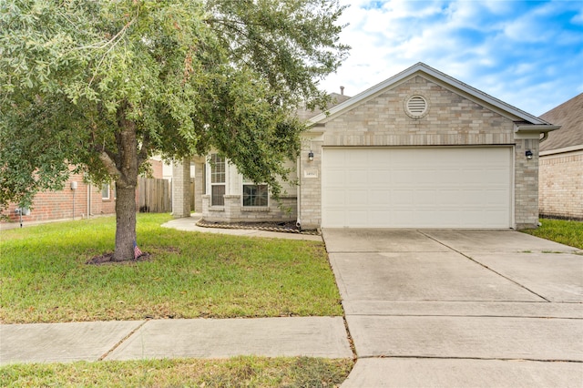 view of front of home featuring a garage and a front yard