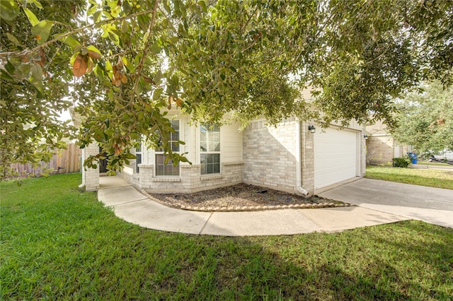 view of property hidden behind natural elements featuring a garage and a front yard