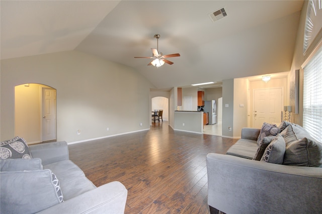 living room with lofted ceiling, dark hardwood / wood-style floors, and ceiling fan