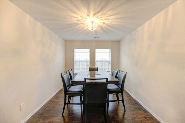 dining area with dark hardwood / wood-style floors