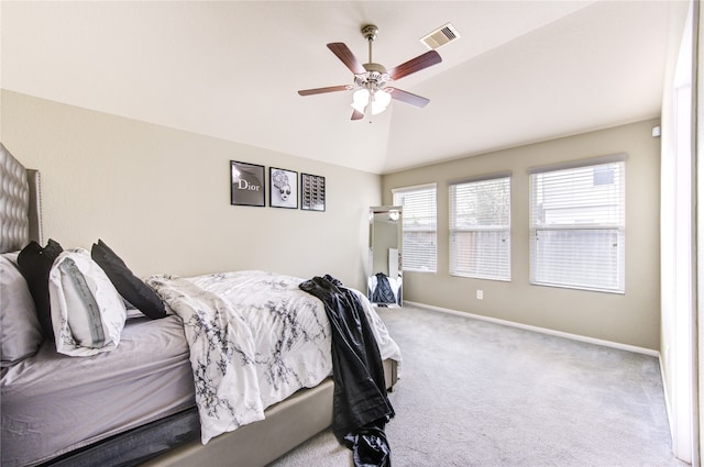 bedroom featuring light carpet, ceiling fan, and vaulted ceiling